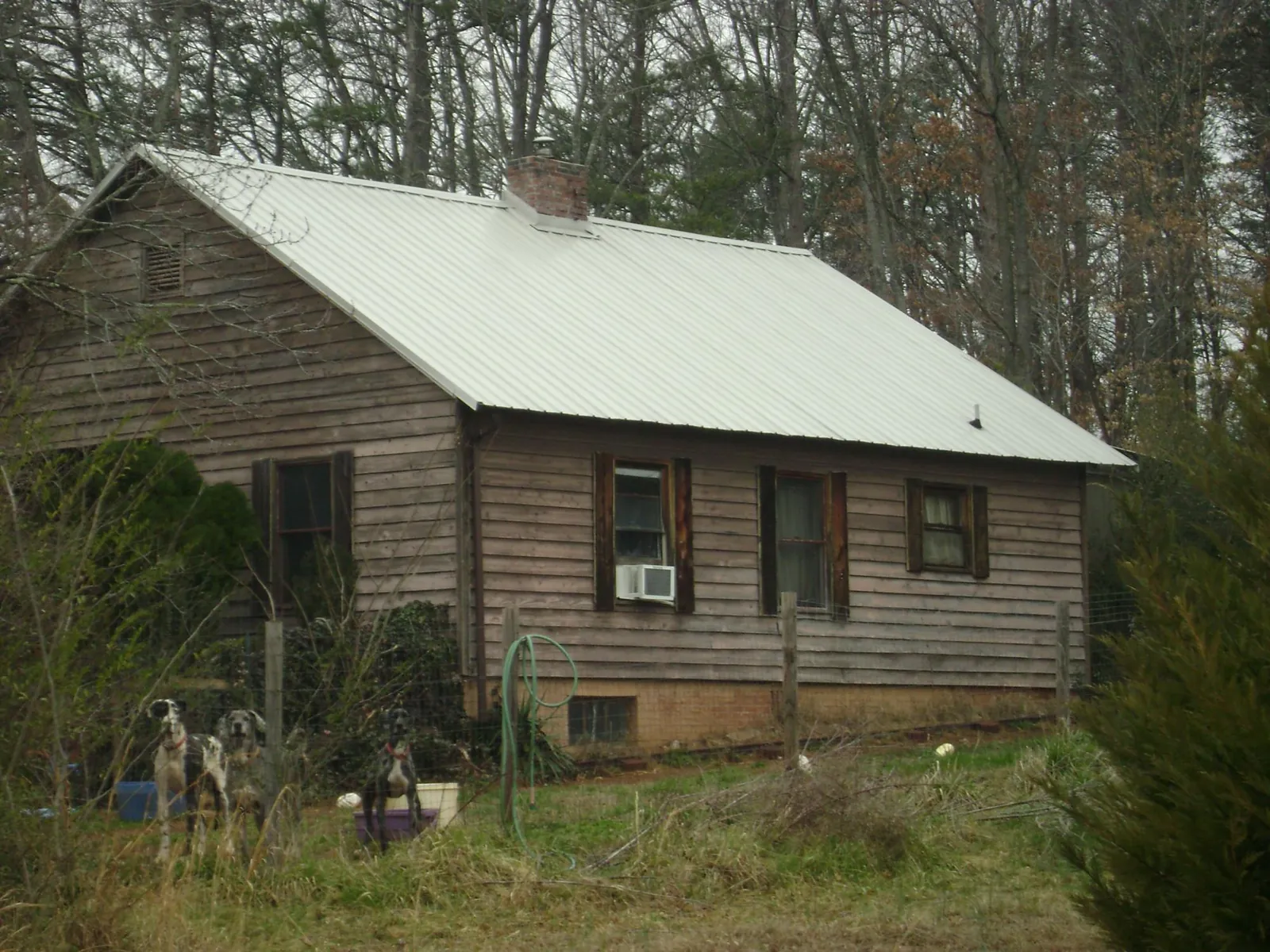 White metal roof on an old wood sided farmhouse, from a Metal Roof Installation job in Marion